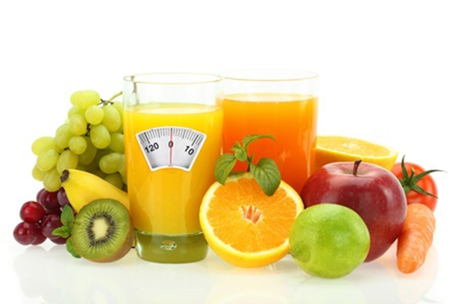 Image showing fruits and fruit drinks with face of scales on  the front of the glass of an orange drink.